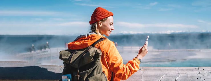 global-travelling-woman-checking-ai-agent-about-personal-insurance-on-cell-phone