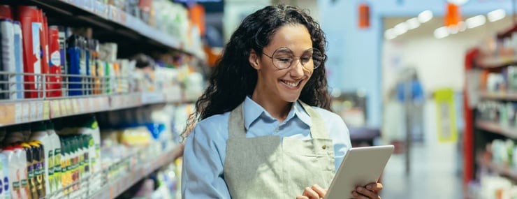 DRUID Retail Profi Case Study Agentic AI showing a grocery store worker smiling