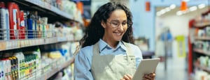 DRUID Retail Profi Case Study Agentic AI showing a grocery store worker smiling