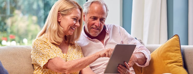 woman-and-man-interacting-with-ai-agent-through-handheld-device-to-pay-utilities