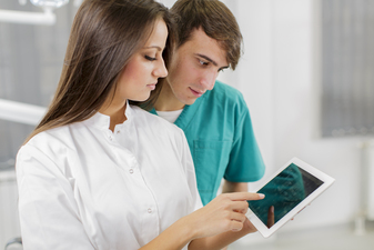 medical staff checking digital devices healthcare
