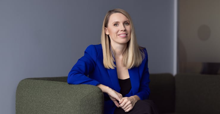 Druid-AI-employee-smiling-while-seated-in-a-modern-office