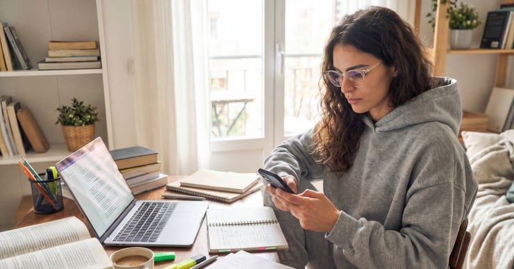 student-using-smartphone-to-message-druid-ai-agent-while-studying