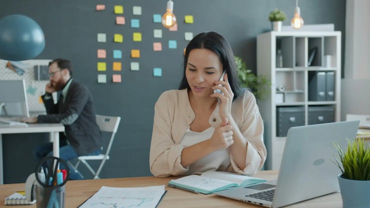 Higher education professional talking on the phone in an office setting